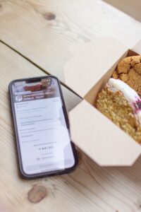 Too Good To Go app on phone next to box of bakes