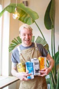 Man smiling cradling milk cartons